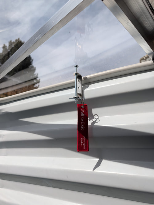 Egress window well cover locks installed on a polycarbonate window well to secure emergency escape.