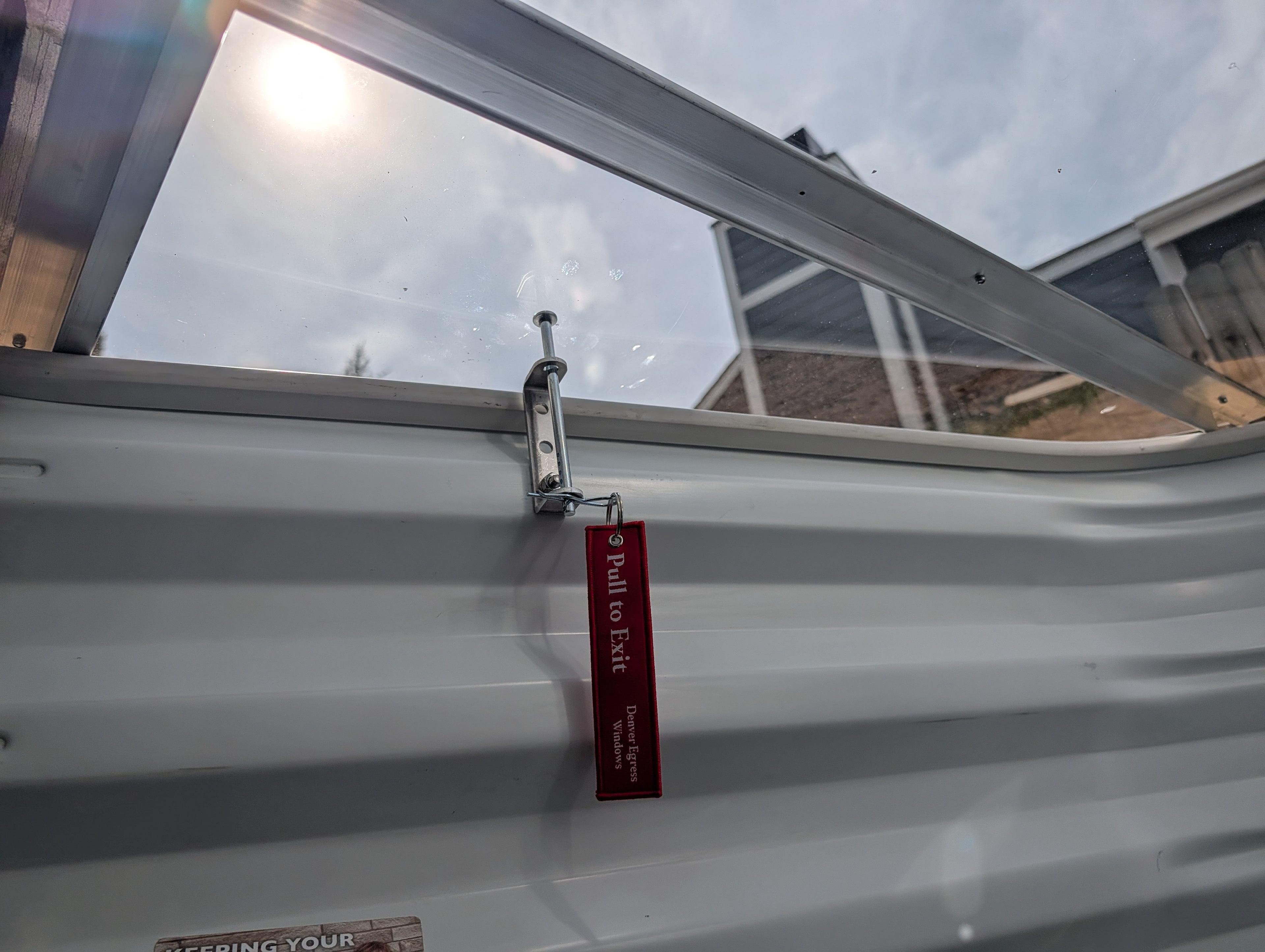 Egress window well cover locks securely fasten window well covers, featuring a safety pull to exit mechanism.