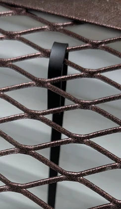 Detail of egress window well grate locks, showcasing the secure locking mechanism for enhanced safety.